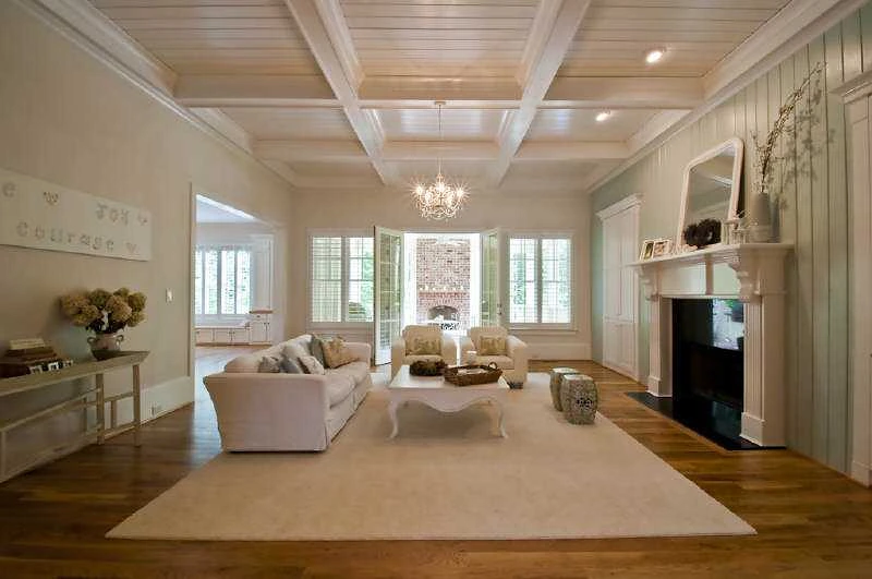 Sunlit great room with coffered ceiling and a limestone fireplace